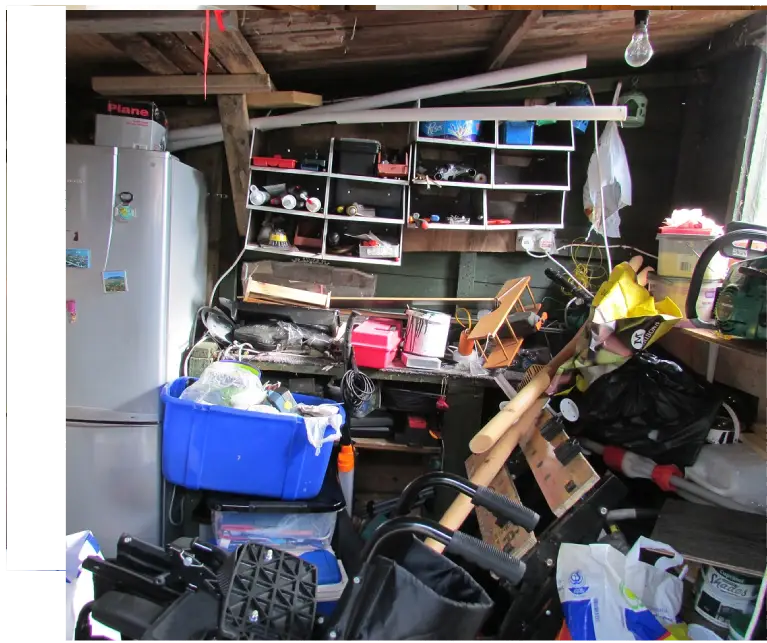 A cluttered room with many items on the floor.