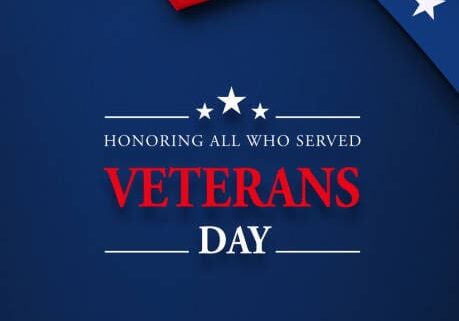 Veteran's Day message sitting below a rippled American flag on navy blue background. Vertical composition with copy space. Directly above. US Veteran's Day concept.